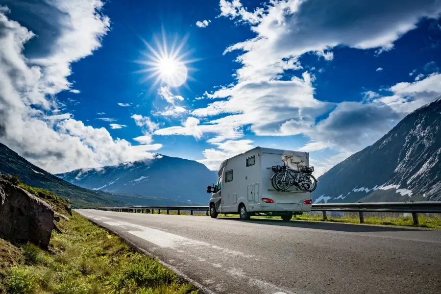 RV with bikes traveling mountain road